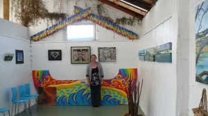 Nadine Herlihy in front of two her works